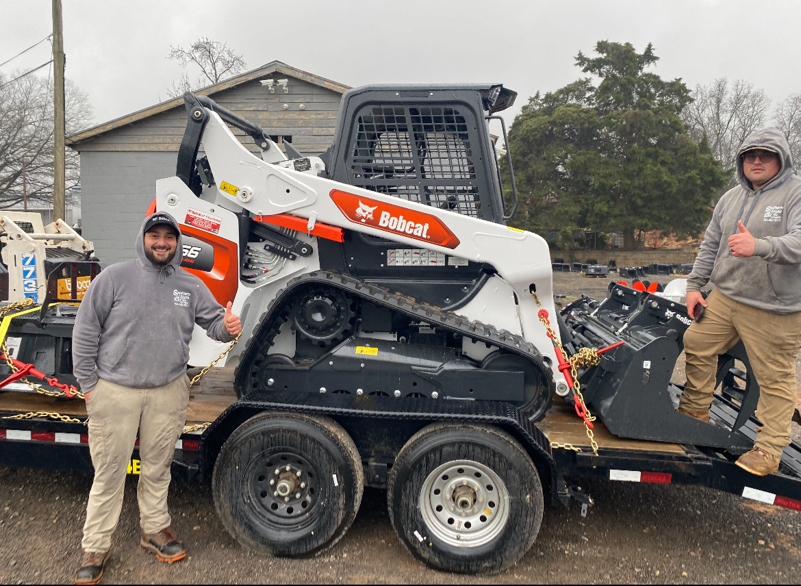 Josh Solano, owner of Southern Style Turf & Design, with Kevin and the new Bobcat T66 track loader at Bobcat of Charlotte