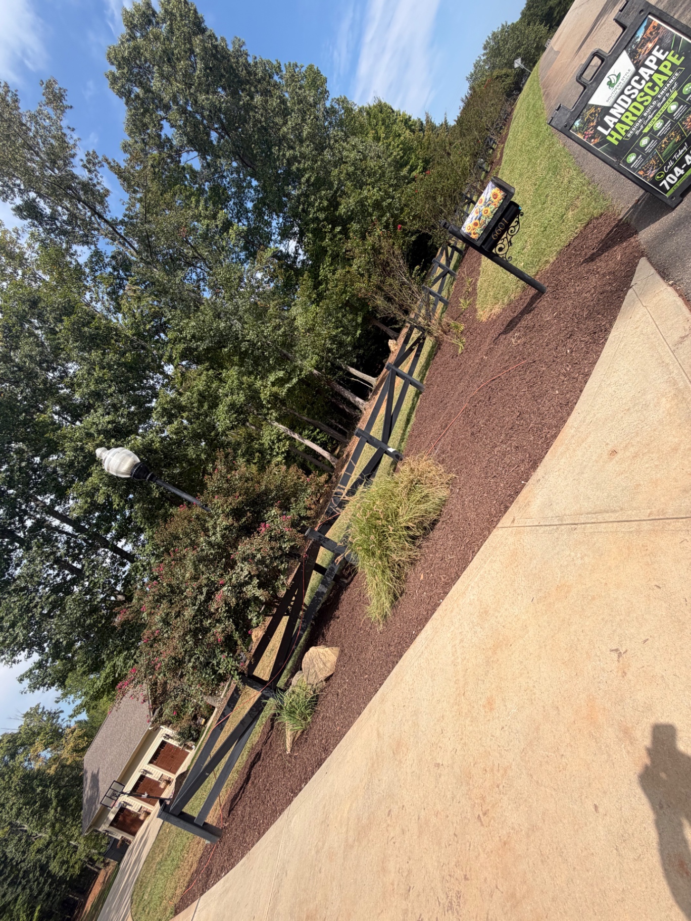 New mulch bed with plantings along the fence line at a Denver, NC property