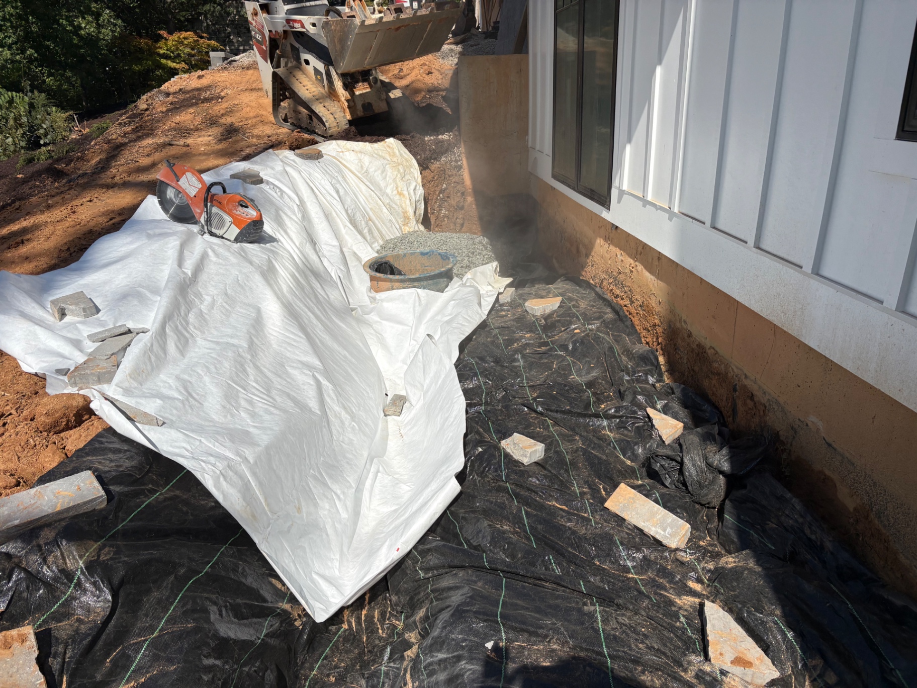 Drainage trench excavated and lined with fabric along a home foundation in the Lake Norman area