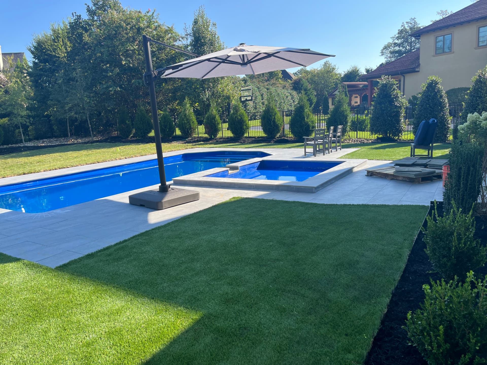 Finished pool patio with paver decking and turf lawn in Lake Norman NC